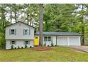 Updated home with a two-car garage and landscaping at 2592 Candler Woods Dr, Decatur, GA 30032