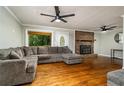 Living room with hardwood floors, fireplace, and large sectional sofa at 1920 Rock House Rd, Lithia Springs, GA 30122