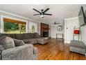 Living room with hardwood floors, fireplace, and large sectional sofa at 1920 Rock House Rd, Lithia Springs, GA 30122