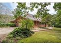 Brick home showcasing the driveway and side yard landscaping at 1827 Lost Mountain Rd, Powder Springs, GA 30127