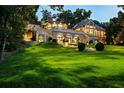 Stunning home showcasing a multi-level design with expansive lawns and gardens at 4665 Riverview Rd, Atlanta, GA 30327