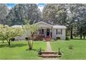 Charming ranch house with a large grassy yard and walkway at 543 Patillo Rd, Stockbridge, GA 30281