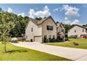 Brick house with a three car garage and a large driveway at 1025 Fable Ln, Hampton, GA 30228