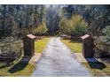 Long driveway entrance to a house through wooded area at 1785 Whitley Rd, Dacula, GA 30019