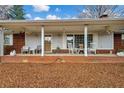 Inviting front porch with rocking chairs and brick flooring at 991 Grassdale Nw Rd, Cartersville, GA 30121