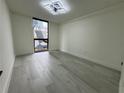 Bright bedroom featuring hardwood floors and large window at 1280 W Peachtree Nw St # 1102, Atlanta, GA 30309