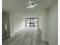 Spacious living room featuring light gray vinyl plank flooring and large windows at 1280 W Peachtree Nw St # 1102, Atlanta, GA 30309