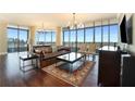 Living room features hardwood floors, a leather couch, and city views at 750 Park Ne Ave # 30W, Atlanta, GA 30326