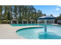 Community pool with mushroom fountain, cabanas, and ample deck space at 600 Silver Moon Dr # 08, Loganville, GA 30052