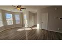 Spacious living room with bay windows and laminate flooring at 7594 Creekside Ln, Riverdale, GA 30296