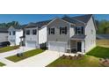 New homes community featuring two-story houses with attached garages and well-maintained lawns at 11964 Conrad Cir, Hampton, GA 30228