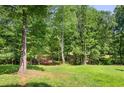 Large grassy backyard with mature trees at 3143 Demooney Rd, College Park, GA 30349