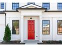 Red front door with white columns and black trim at 428 10Th St, Auburn, GA 30011