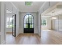 Elegant entryway with a black metal arched door and hardwood floors at 2381 Kilgore Road (Lot 4) Rd, Buford, GA 30519