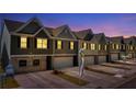 Row of new townhomes at night at 11719 Chatham Dr, Hampton, GA 30228