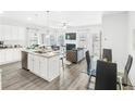 Open concept kitchen with island, stainless steel appliances, and granite countertops at 11719 Chatham Dr, Hampton, GA 30228