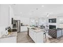 Open concept kitchen with island, stainless steel appliances, and granite countertops at 11682 Chatham Dr, Hampton, GA 30228