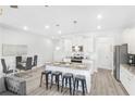 Modern kitchen with an island, stainless steel appliances, and white cabinets at 11682 Chatham Dr, Hampton, GA 30228