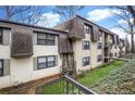 Townhouse community featuring multiple units and lush green landscaping at 169 Barone Nw Pl, Atlanta, GA 30327