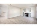 Spacious living room with fireplace and neutral carpet at 6674 Eastbriar Dr, Lithonia, GA 30058