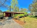 Brick ranch house with mature trees and yard at 650 Lyric Nw Way, Atlanta, GA 30318