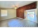 Living room with brick accent wall and flooring at 650 Lyric Nw Way, Atlanta, GA 30318