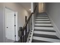 Modern staircase with dark wood and metal railing at 577 Fundao Ln # 14, Lawrenceville, GA 30046