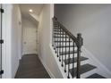 Modern staircase with dark wood and metal railing at 577 Fundao Ln # 14, Lawrenceville, GA 30046