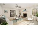 Bright living room with fireplace, large windows, and access to dining area at 1365 River Club Ne Dr, Conyers, GA 30012