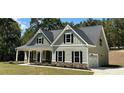 Two-story house with gray siding, stone accents, and a front porch at 22 Stratford Way, Kingston, GA 30145