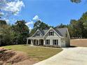 Two-story house with gray siding, stone accents, and a front porch at 22 Stratford Way, Kingston, GA 30145