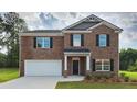 Two-story brick home with a white garage door and black shutters at 5680 T. A. Bryant Way, Stonecrest, GA 30038