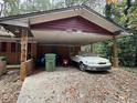 Carport with a white car and green trash cans at 2364 El Paso Sw Rd, Atlanta, GA 30331