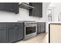 Stainless steel range and dark gray cabinetry in modern kitchen at 110 Sheridan Ne Dr, Atlanta, GA 30305