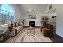 Virtually staged living room with fireplace and large window at 5789 Wellborn Creek Dr, Lithonia, GA 30058