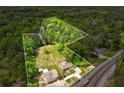 Aerial view of property featuring two houses and expansive wooded lot at 3813 Stonewall Tell Rd, South Fulton, GA 30349