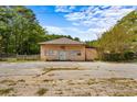 Building with light peach exterior, ample parking, and mature trees nearby at 3813 Stonewall Tell Rd, South Fulton, GA 30349