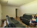 Living room with two black leather sofas and wood flooring at 3321 S Norcross Tucker Rd, Tucker, GA 30084