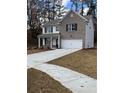 Two-story house with gray brick, white garage door, and landscaping at 2270 Highridge Point Dr, Lithia Springs, GA 30122
