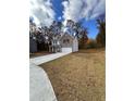 Two-story house with gray brick, white garage door, and landscaping at 2270 Highridge Point Dr, Lithia Springs, GA 30122