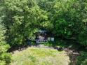 House nestled in a wooded area, with a visible swimming pool at 731 Bolton Nw Rd, Atlanta, GA 30331