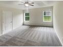 Spacious bedroom with neutral carpeting and two windows at 261 Christian Cir, Carrollton, GA 30116