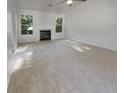 Spacious living room with a fireplace and neutral carpeting at 5844 Broadleaf Way, Atlanta, GA 30349