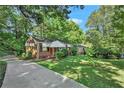 Front view of a brick ranch house with a driveway and yard at 2576 Godfrey Nw Dr, Atlanta, GA 30318