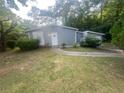 Gray brick ranch house with a grassy front yard at 366 Hamilton E Holmes Nw Dr, Atlanta, GA 30318