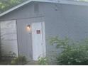 Gray brick house with a white door and boarded-up windows at 366 Hamilton E Holmes Nw Dr, Atlanta, GA 30318