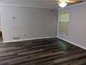 Living room with dark wood-look floors and a window at 2936 Parc Lorraine # 2936, Lithonia, GA 30038
