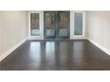 Sunlit living area with dark hardwood floors and French doors at 51 Holt Ne Rd, Marietta, GA 30068