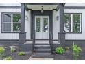 Modern front entry with double doors and black brick accents at 8660 Hightower Trl, Snellville, GA 30039