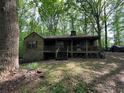 One-story house with porch and large trees at 2576 E Paulding Dr, Dallas, GA 30157